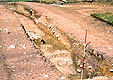 Section across the front of the bank and deposits on the berm, including the ditch ( period 4)