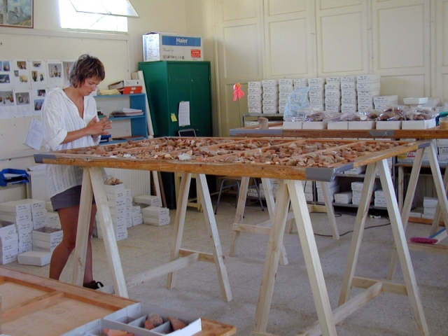 Figure 6: Pottery specialist Kristina Winther Jacobsen analysing pottery in the artefact lab in Tembria school, 27 July 2002. Photograph: Vasiliki Kassianidou. 