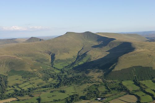 Figure 2: View of the Brecon Beacons upland landscape in south Wales showing the present-day open landscape on the summit with improved land and woodland on the lower slopes. (Image: T. Driver, Crown Copyright RCAHMW, AP-2007_2737)