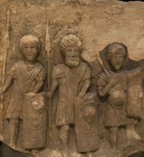 Gravestone relief of Roman soldiers displayed in the National Museum of Scotland, 2nd Century CE. Image credit: W. Givens