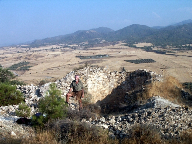 Figure 30: Architectural historian Ian Evans by a lime kiln (BU0141) on Koronia hill, with a view southwards to where the plains meet the Troodos Mountains in the Nikitari/Mandres area. Photograph: Michael Given. 