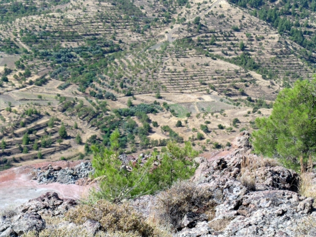 Figure 49: Roman mining settlement of Litharkies (TS06; below and left of the two squarish ploughed fields in the centre), seen from near the top of Alestos to the north. Photograph: Kristina Winther Jacobsen.