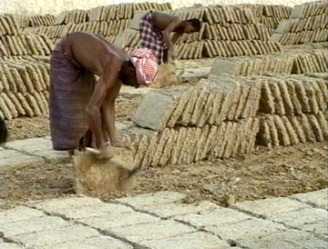 Image of the process of mud brick making.