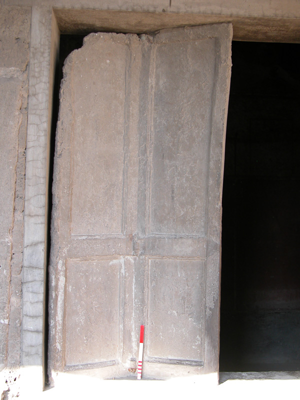 Cast of the wooden shutter of a window in the Villa of the Mysteries. Note the remains of an iron hinge at the base of the join