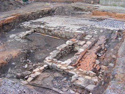 General view of Area A almost fully excavated showing a collapsed brick vault of a cellar probably belonging to 6 Little Anne St; the cobbled surface of Pratten's Court and kerbing