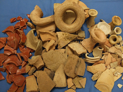 Selection of fine and specialist wares from cess pit 1067, showing decorated samian bowls (left), Dressel 20 olive oil amphorae (centre) and white ware flagons (right). Notice the lack of drinking vessels in the group