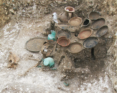 Grave 6260, A2 Pepperhill to Cobham road widening scheme, Kent (Allen et al. 2012), showing the in situ arrangement of pottery vessels on the remains of a table. © Oxford Archaeology.
