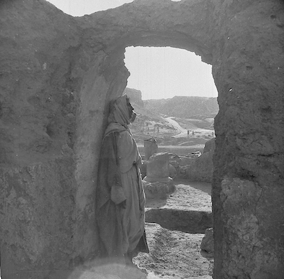Side on view of a man standing in stone doorway