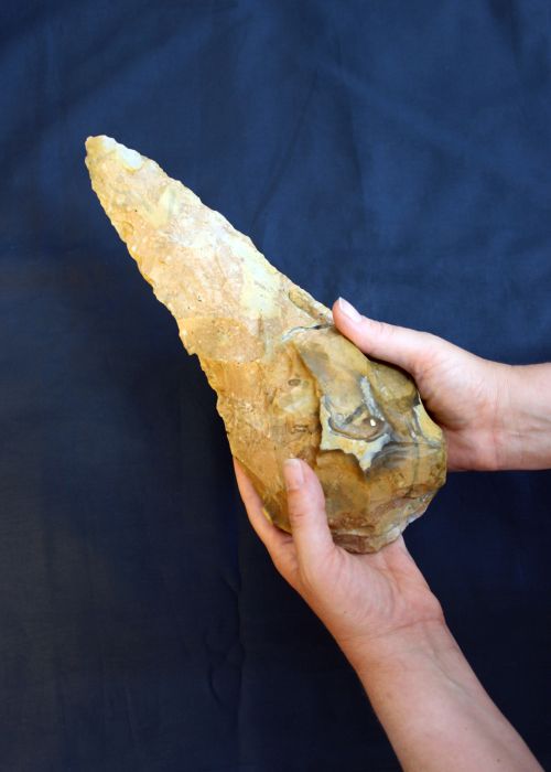 Giant handaxe in someone's hand for scale