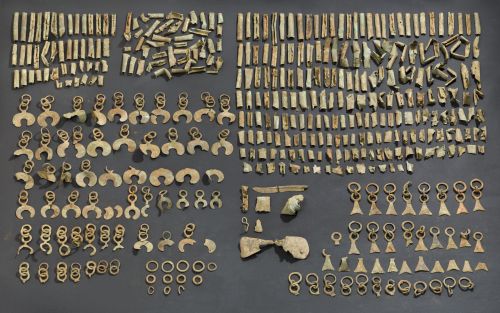 A museum display of a large number of small archaeological artifacts