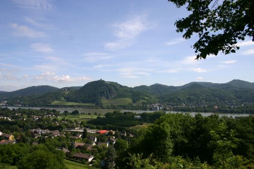 View of Siebengebirge hills in the background with houses and vegetation in the foreground, with the river Rhine inbetween
