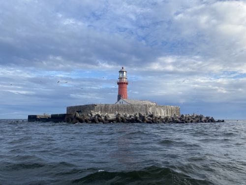 A lighthouse on a small artificial island in the sea