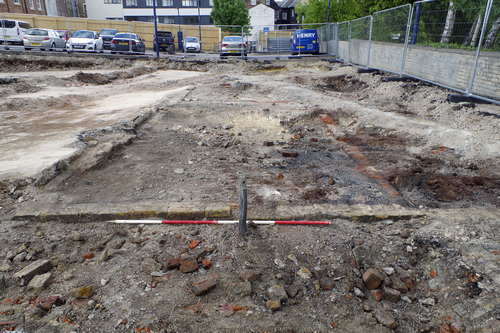 excavated trenches and brickwork infront of car park