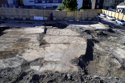 excavated brickwork and cobblestones