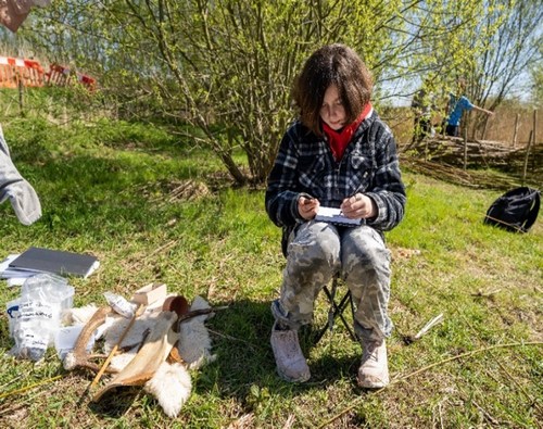 A child sitting on a chair outside