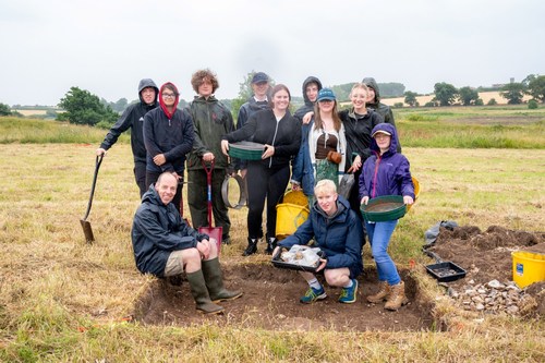 Group photo of smiling student participants at Warham Camp