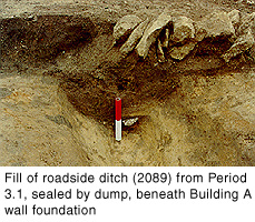 Fill of roadside ditch (2089) from Period 3.1, sealed by dump, beneath Building A wall foundation.